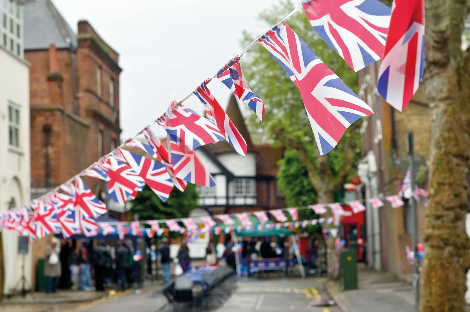 Image of Queens jubilee celebrations with bunting hanging between a street.